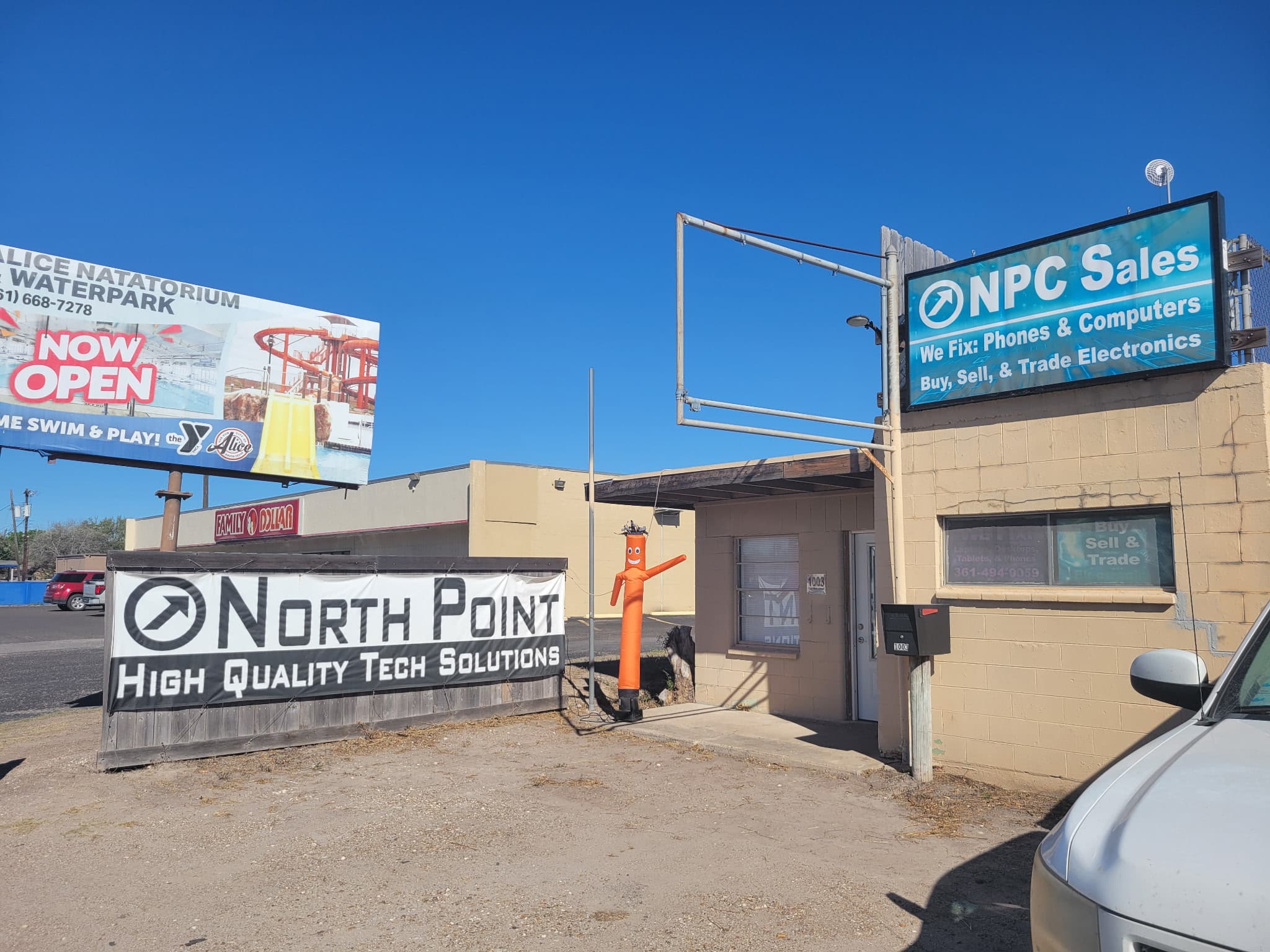 NPC Sales storefront at 1003 E Main St in Alice TX, with the North Point Computers banner and orange tube guy out front
